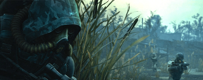 Gas-masked soldier crouching in grass, armed soldiers behind
