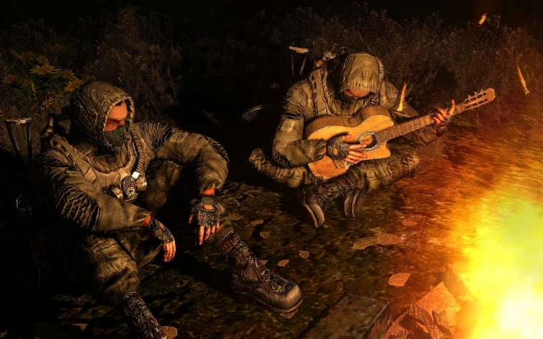 Two hooded soldiers sit by campfire, one plays guitar