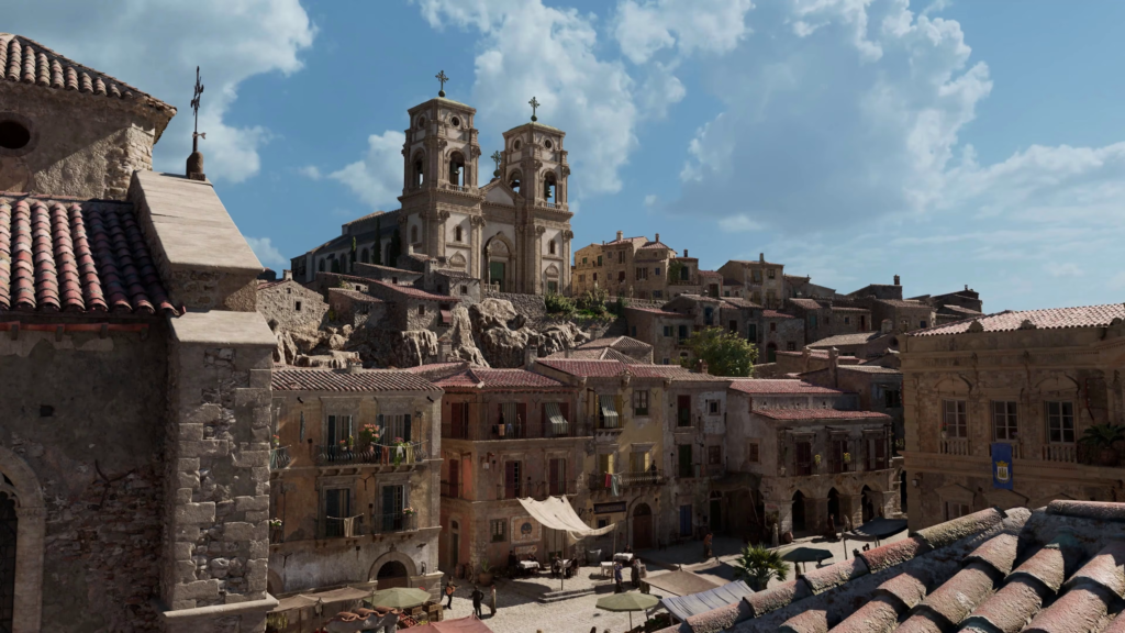 Stone village with church towers under blue sky