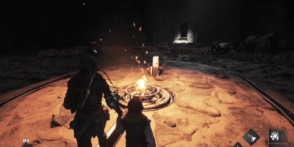 Characters stand by a fire in a dark setting.
