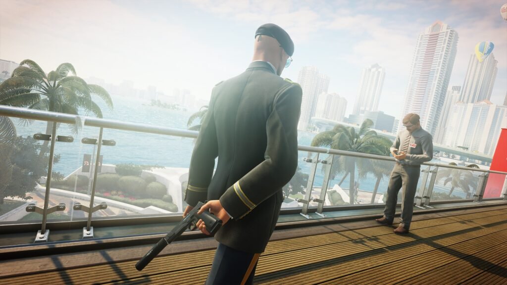 Man holding silenced pistol on balcony overlooking city