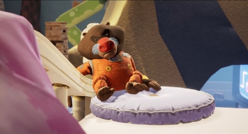 Stuffed bear sitting on purple cushion indoors